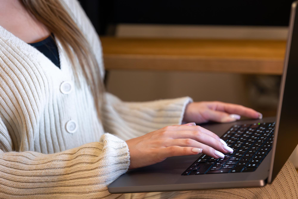 Woman writing a blog on her laptop